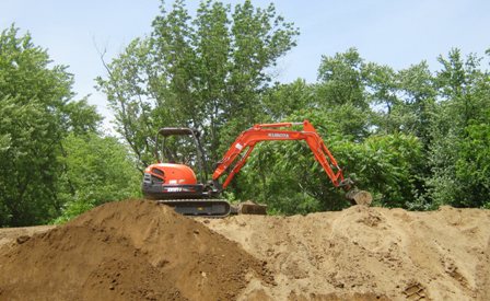 121 Excavator on Topsoil Pile